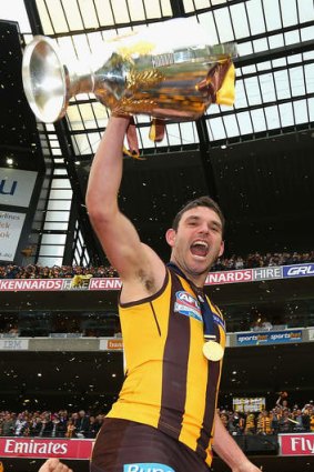 Brent Guerra celebrates with the 2013 AFL Premiership Cup.