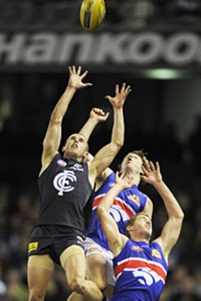 Carlton's Marc Murphy attempts to mark over two Western Bulldogs players.