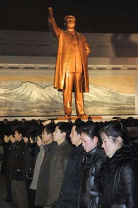 Pyongyang residents observe silent prayers in front of a statue of North Korean founder Kim Il-sung as they mourn the death of North Korean leader Kim Jong-il.