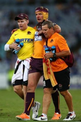 Conscious decision: Brisbane's Todd Lowrie is assisted from the field on Friday night.