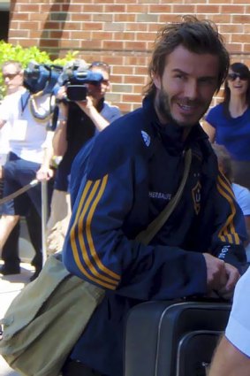 Footballer David Beckham wearing an over-shoulder bag.