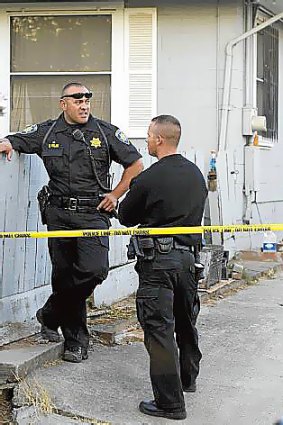 Police officers guard the home of Phillip and Nancy Garrido in Antioch, California.