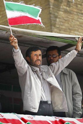 Mahmoud Ahmadinejad gestures to supporters at his last election campaign rally.