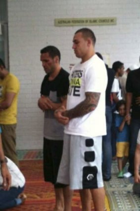 Blake Ferguson prays with his mentor and second cousin Anthony Mundine in Zetland on Friday.