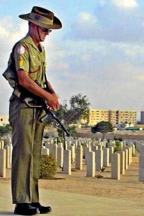 An Australian soldier gives his respect at the Commonwealth grave yard in El-Alamein near Cairo.