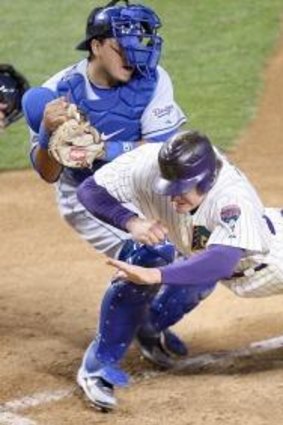 Fierce rivals: Los Angeles Dodgers catcher Dioner Navarro tags out Arizona Diamondbacks runner Eric Brynes.