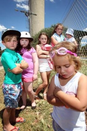 Change of heart: Dejected children outside the town pool will soon be happily splashing about.