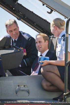 His Royal Highness, the Duke of Cambridge sits in the cockpit of an F/A-18F Super Hornet while Chief of Air Force, Air Marshal Geoff Brown, AO and Flight Lieutenant Jasmine Richards explain some of its features.