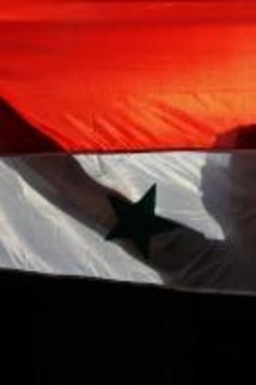 A demonstrator holds a Syrian flag during a protest against a possible military strike against Syria by the US.