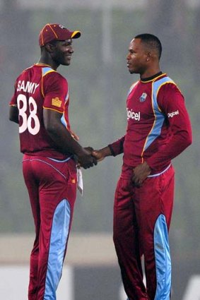West Indies captain Darren Sammy congratulates Marlon Samuels after the match.