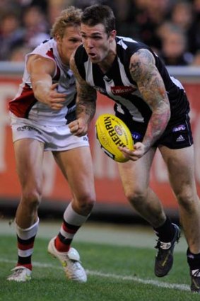 Dane Swan (right) is one of two Collingwood midfielders who will not be in action against Melbourne.