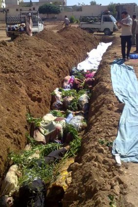 The most appalling incident yet ... bodies lie in a shallow grave in Darayya.