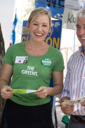 Queensland Senator Larissa Waters and Greens candidate Geoff Ebbs hand out how to vote cards at West End State School.