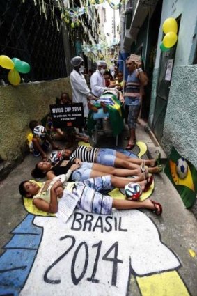 Rio residents simulate bad service at a public hospital during a protest against the 2014 World Cup.