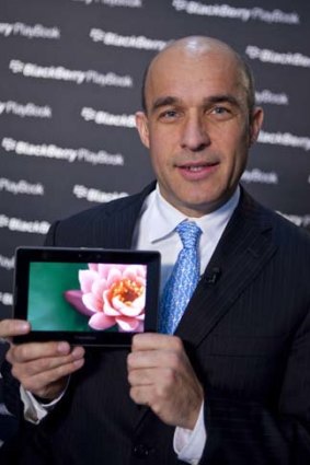 Jim Balsillie, co-chief executive officer of Research In Motion, holds up the PlayBook tablet computer during a Bloomberg Television interview in New York.