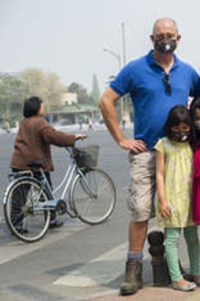 Breathe no evil: Stephanie Teoh, Trevor Marshallsea and their daughters Lani and Evie near their Beijing apartment.