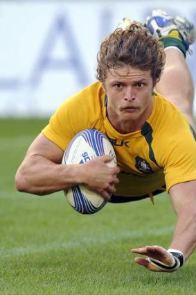 Hair raising: Nick Cummins was Australia's best against Italy in Turin.