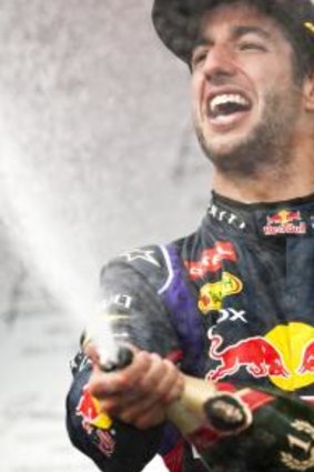 Ricciardo celebrates on the podium.