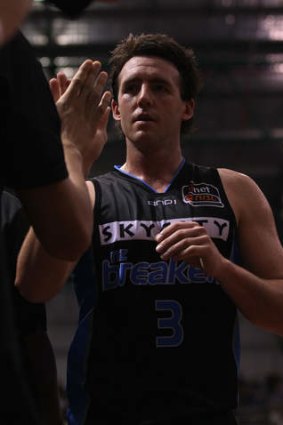Daryl Corletto of the Breakers is congratulated as he comes off the court.