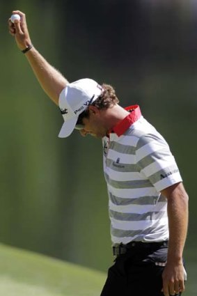Adam Scott reacts to his hole-in-one on the 16th hole.