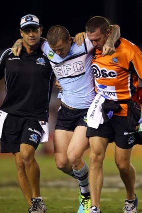Feared serious injury: Todd Carney is helped from the field.