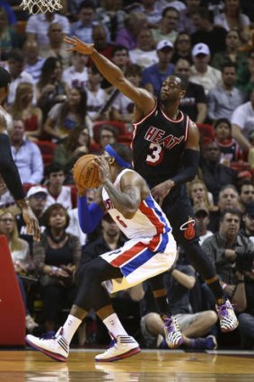Miami Heat's Dwyane Wade  blocks Detroit Pistons forward Josh Smith.
