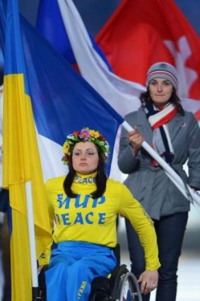 Flagbearer and Cross Country skier Lyudmyla Pavlenko of Ukraine enters the stadium.