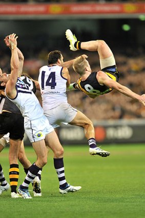Jack Riewoldt takes a tumble after flying for a mark.