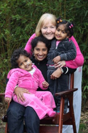In the pink ... formerly conjoined twins Krishna (left) and Trishna with their Bangladeshi mother, Lovely Goldar, and their Australian foster mother, Moira Kelly.