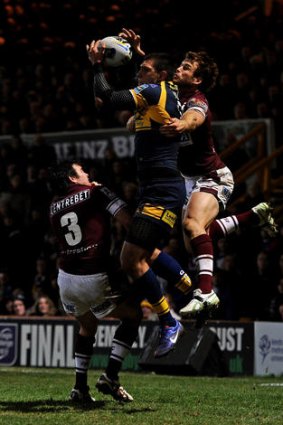 Soaring high ... Ryan Hall of Leeds Rhinos jumps to score his second try.