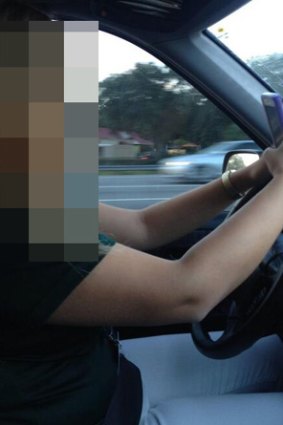 It is illegal to take photographs with your phone while driving.