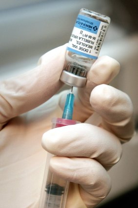 A registered nurse in the US draws a dose of mumps-measles-rubella, or MMR vaccine. 