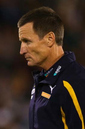 Eagles coach John Worsfold walks from the ground after the half-time break.