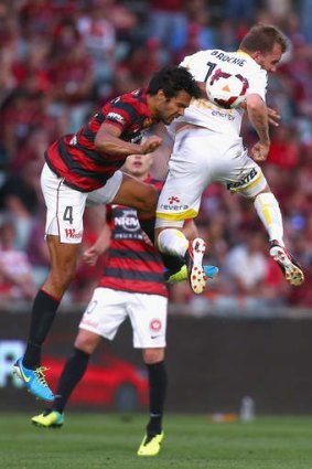 Up for the challenge: Nikolai Topor-Stanley of the Wanderers is beaten to the ball by Wellington's Jeremy Brockie.