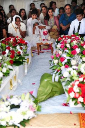 Mourners at the funeral of Fijians visting Canberra Ram and Padmawati Deo at the Deo family home in Chishoolm, Canberra.