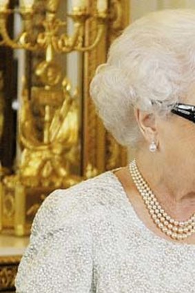 Dressed to impress ... the Queen wearing 3D glasses studded with Swarovski crystals in the form of the letter Q.