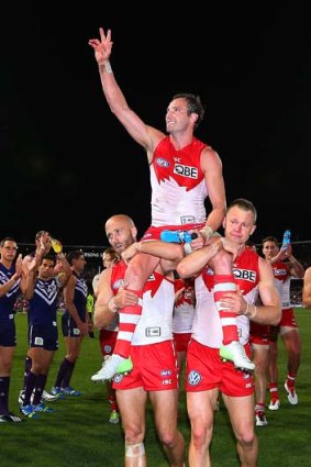 Jude Bolton is chaired off by Jarrad Mcveigh (left) and Ryan O'Keefe after the Swans were eliminated.