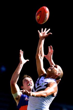 Air time: Bulldog Ayce Cordy (left) and Michael Johnson aim high during the Dockers' victory at Etihad Stadium.
