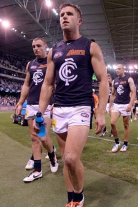 Not a good feeling: Carlton captain Marc Murphy leads the team back after losing to Geelong.