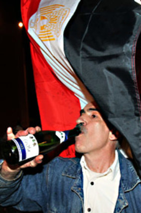 A Lebanese man celebrates Mubarak's resignation outside the Egyptian embassy in Beirut.