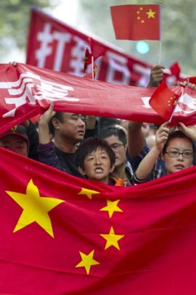 Flagging their anger: Anti-Japan protesters take to the streets in Chengdu, Sichuan Province
