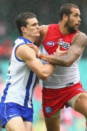 In the action: Scott Thompson competes for the ball against Lance Franklin. 