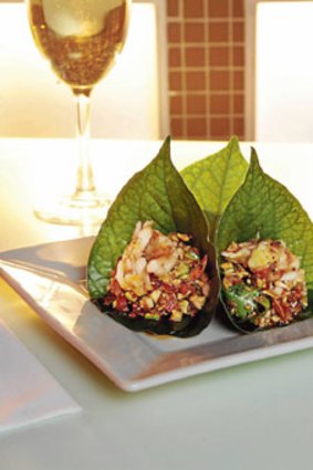 Betel leaf with grilled prawn, roasted coconut, chilli, lime, ginger, peanuts and caramel sauce.