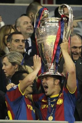 Barcelona's Pedro Rodriguez Ledesma (left) and David Villa celebrate with the Champions League trophy at Wembley Stadium.