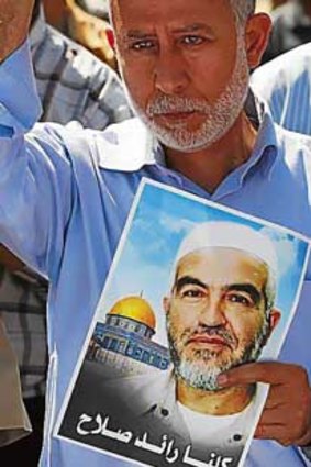 Palestinian Islamic Jihad leader Muhammed Al Hindi holds a picture of Sheik Raed Salah, the leader of the northern branch of the Islamic Movement in Israel.