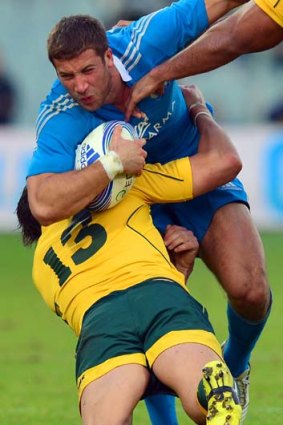 Get stuck in &#8230; Adam-Ashley Cooper tackles Tommaso Benvenuti in Saturday's match against Italy in Florence.