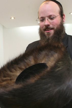 Moshe Weiner holds a handmade shtreimel at his Jerusalem workshop.