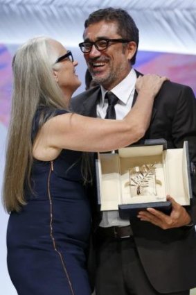Cannes jury president Jane Campion kisses director Nuri Bilge Ceylan, Palme d'Or award winner for his film 'Winter Sleep'.