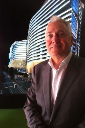 Architect and developer Tony John, from the Anthony John Group in front of an artists impression of his company's Southpoint development at South Bank.