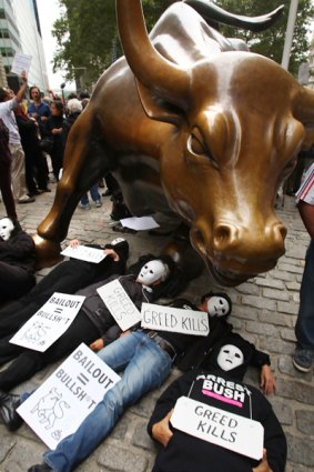 Protesters lie underneath the Wall Street bull during a rally against the proposed bail-out.